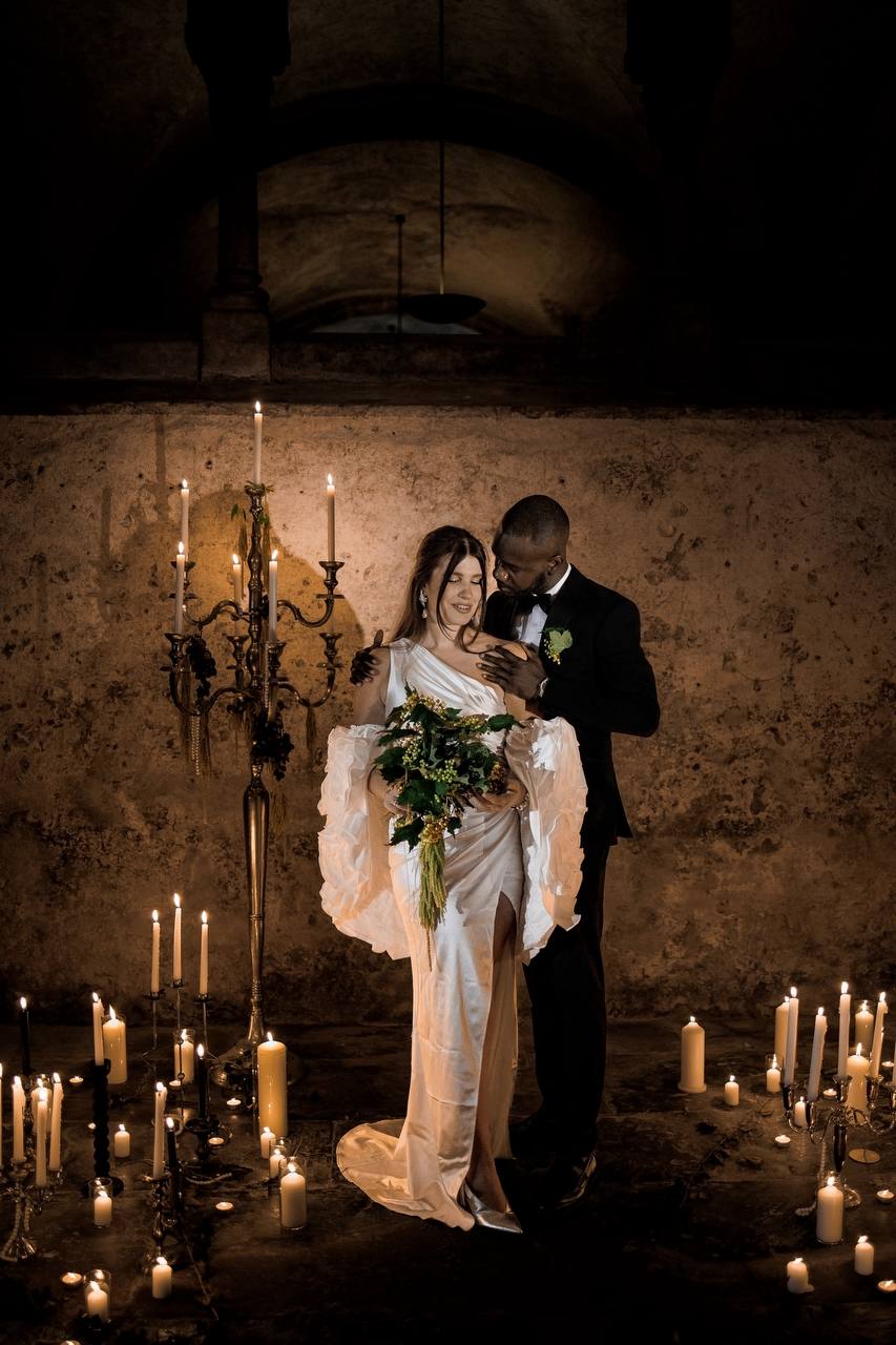 Bride and groom together in a romantic candlelit wedding setting