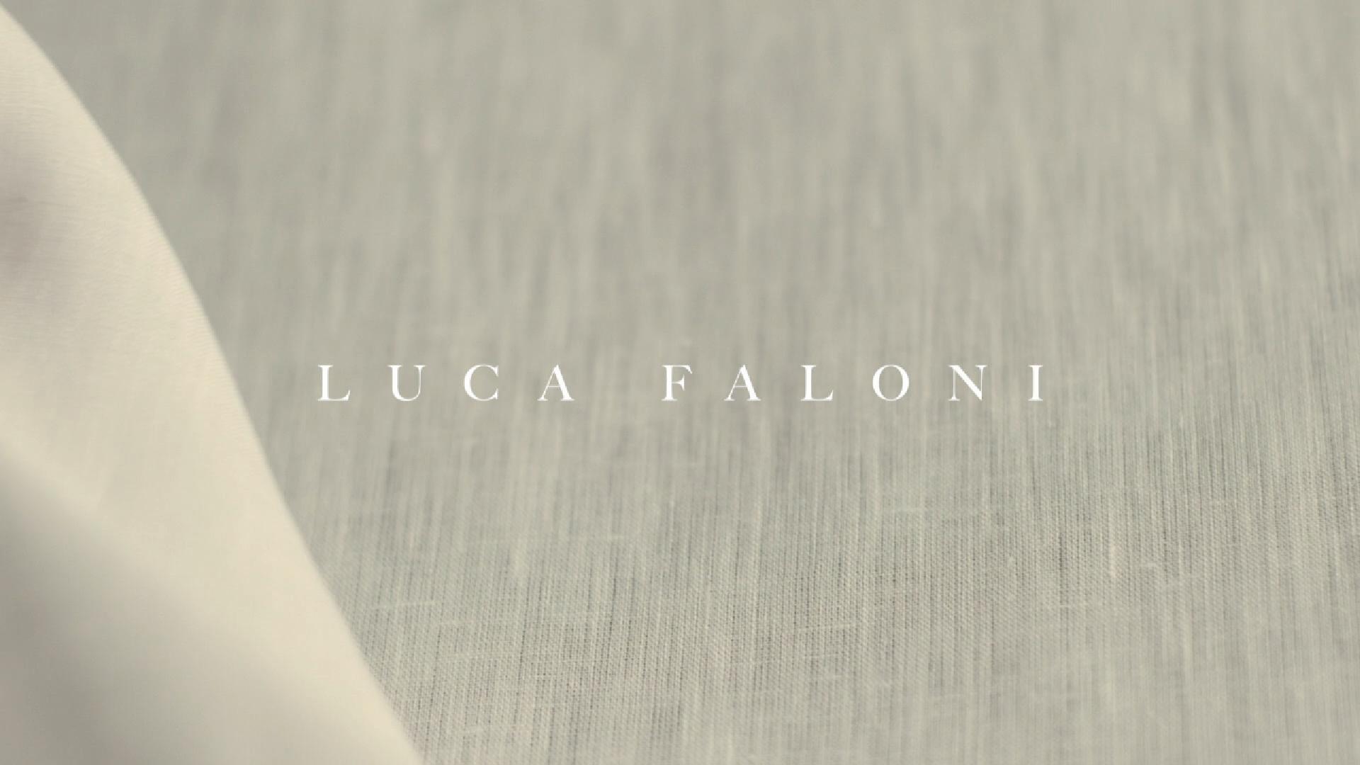 Black-and-white photo of a band rehearsal with guitarist, drummer, and people gathered under string lights.