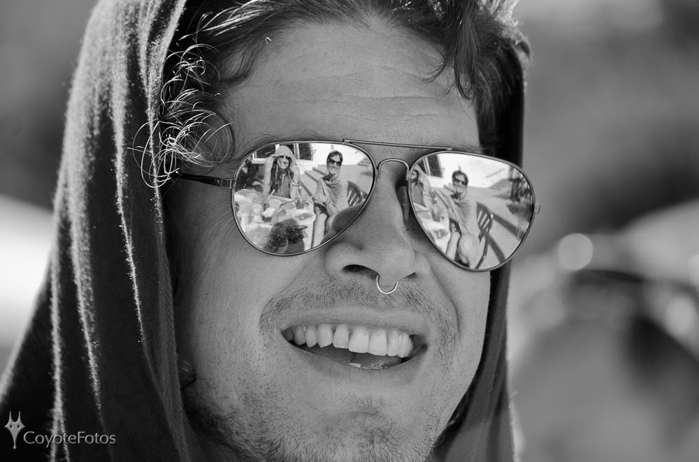 woman in blue denim jacket and white skirt standing beside brown wooden table