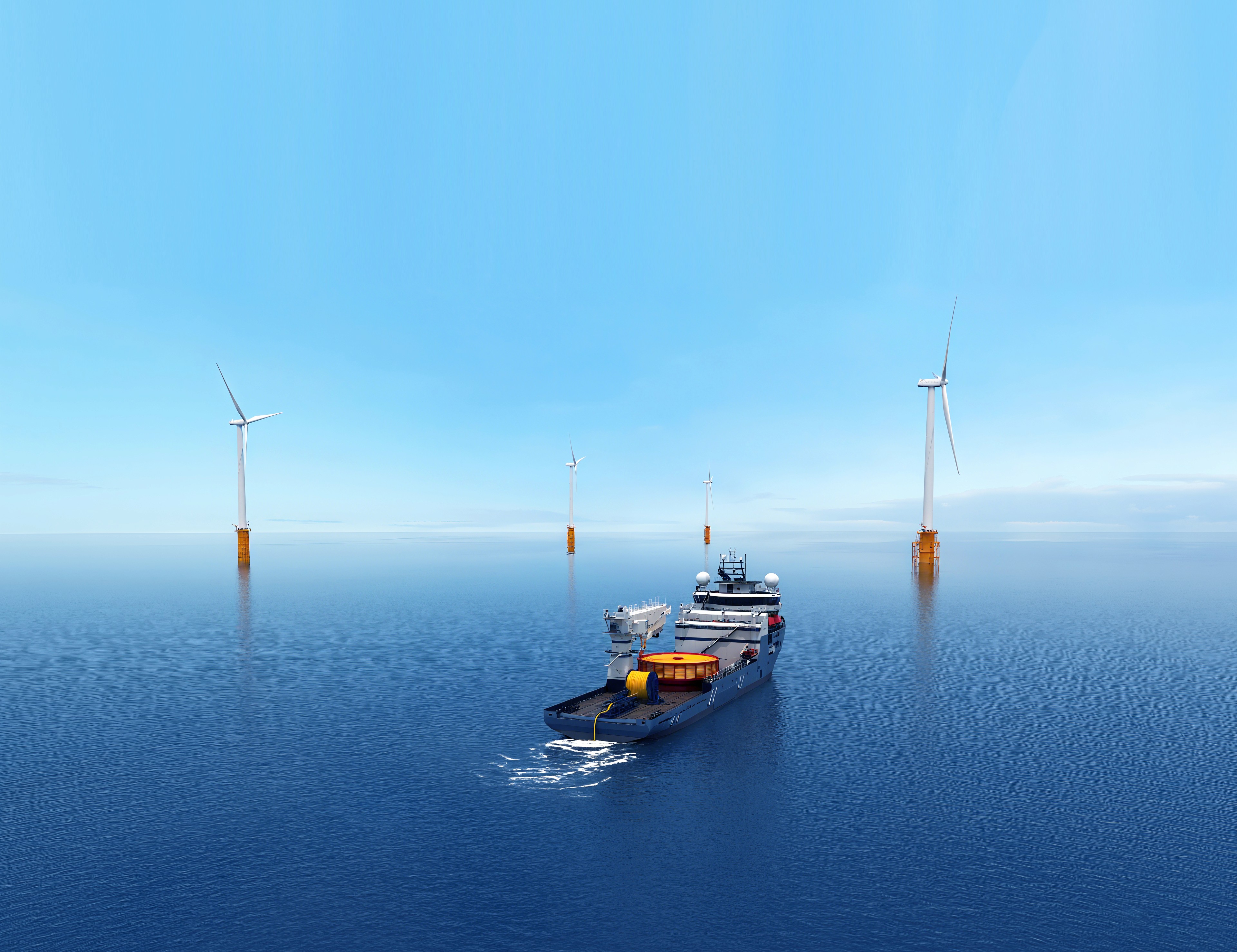 a woman sitting at a table with two laptops