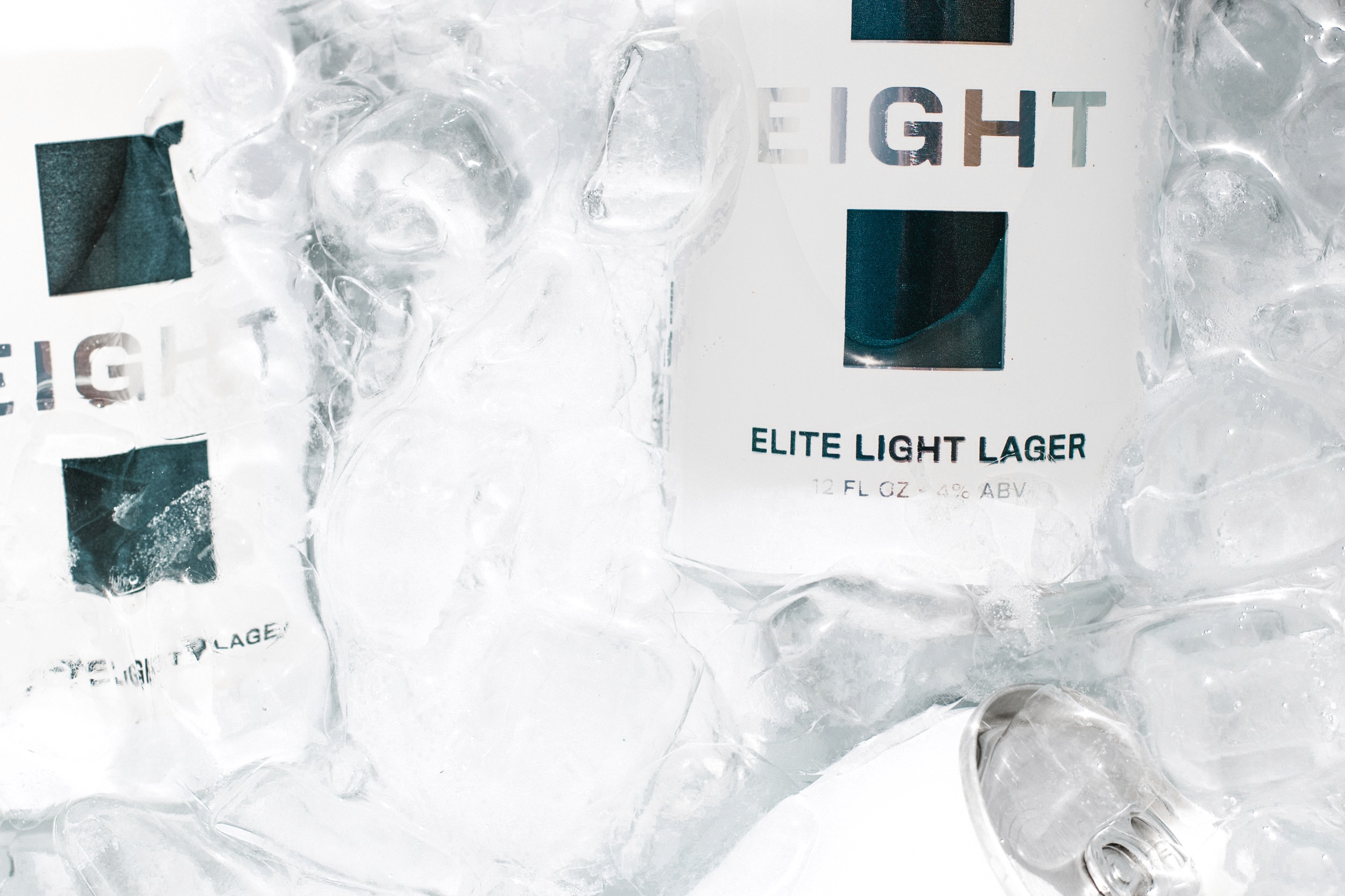 Detail shot of EIGHT beer branding partially visible through ice, styled for lifestyle beverage marketing.