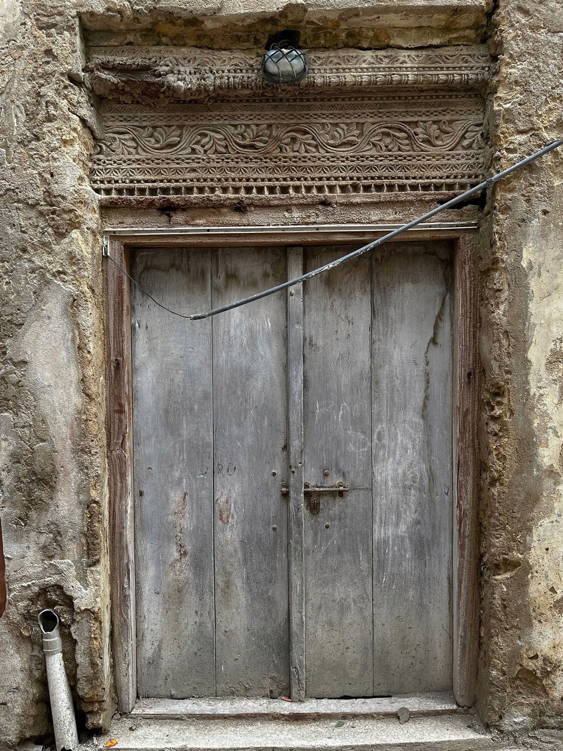 Wood door with geometric carvings.