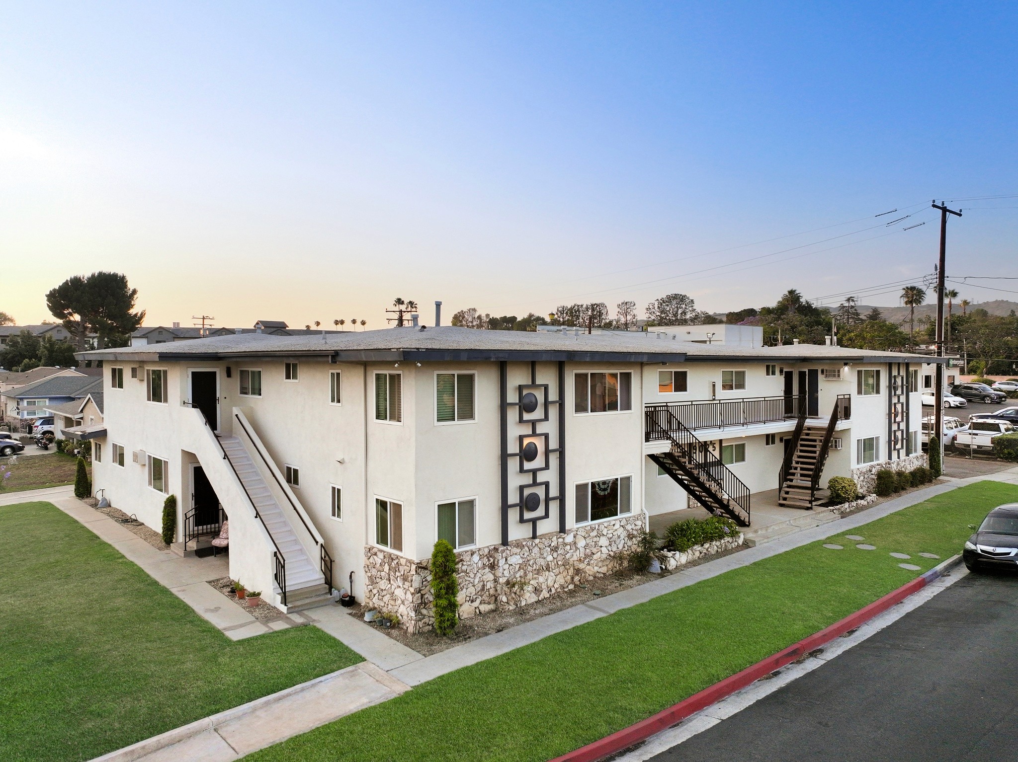 9025 Mills Avenue elevated exterior shot with updated facade, stone accents and walkway access.