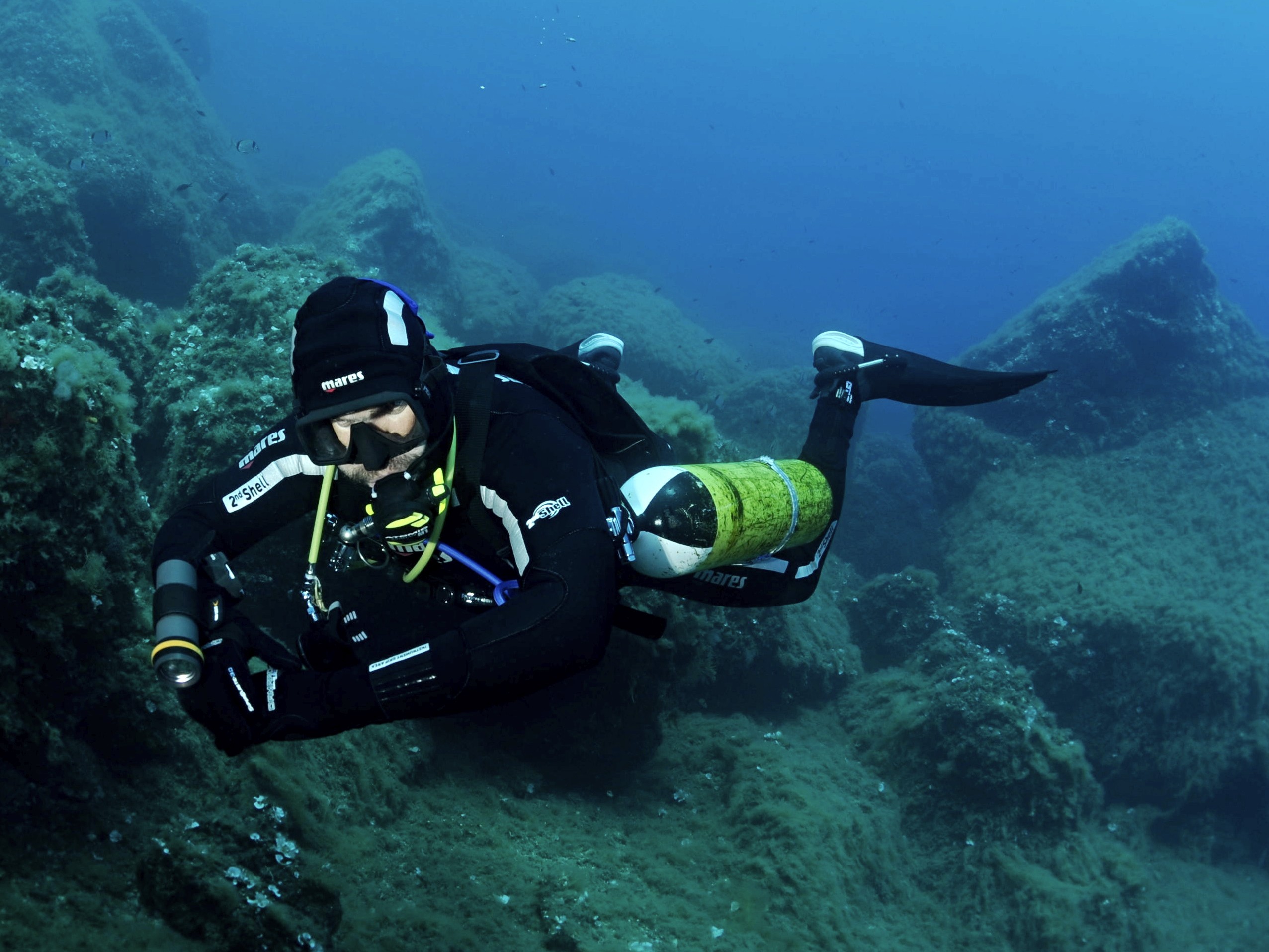 man in black shorts diving on water