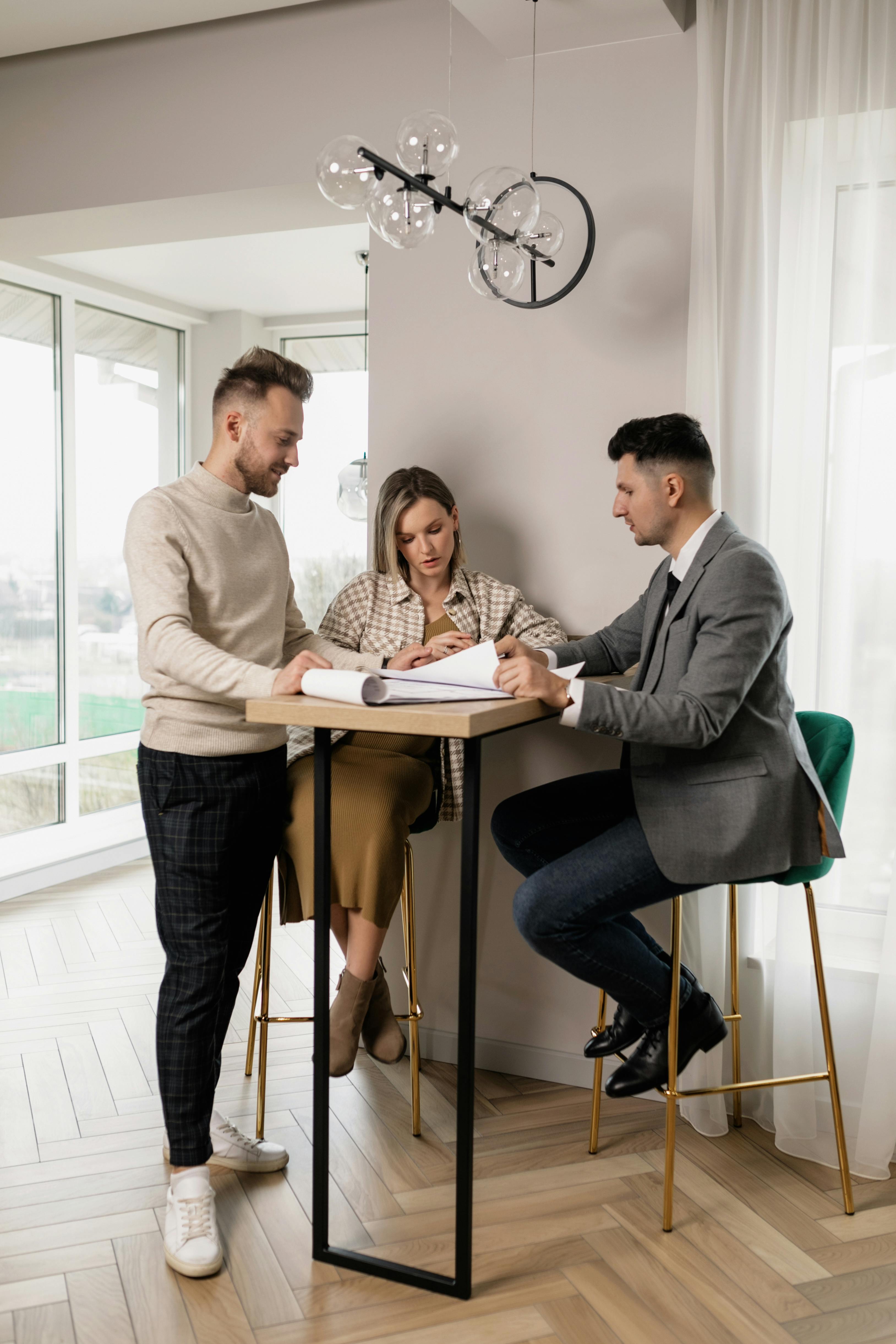 Dynamic sales team in discussion around a high-top table.