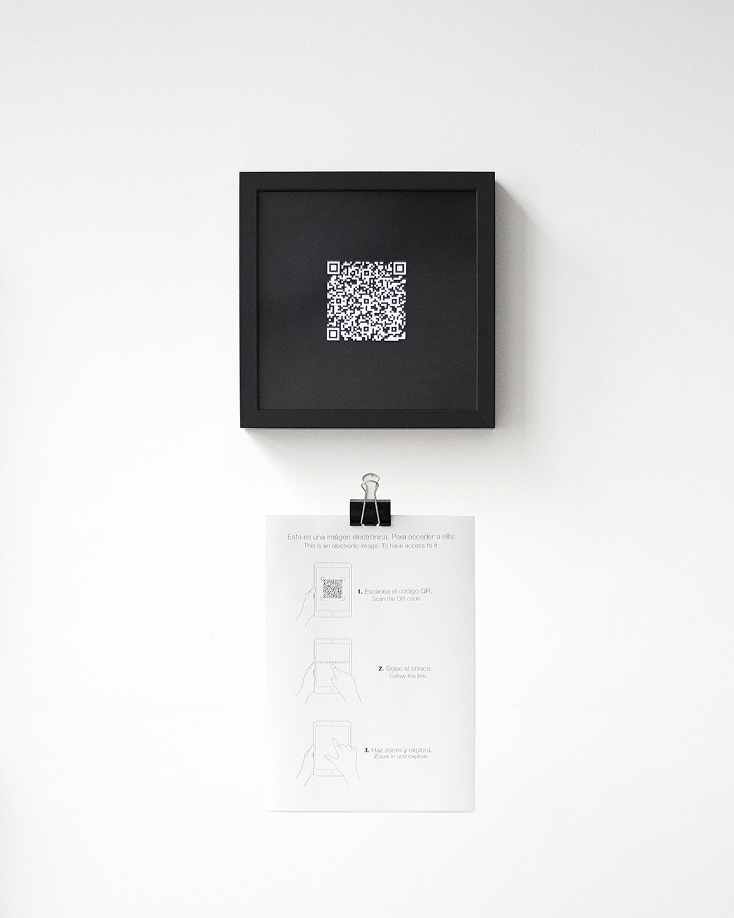 Room installation of the work Hotnoise. QR framed in black. Printed instructions hung on the wall