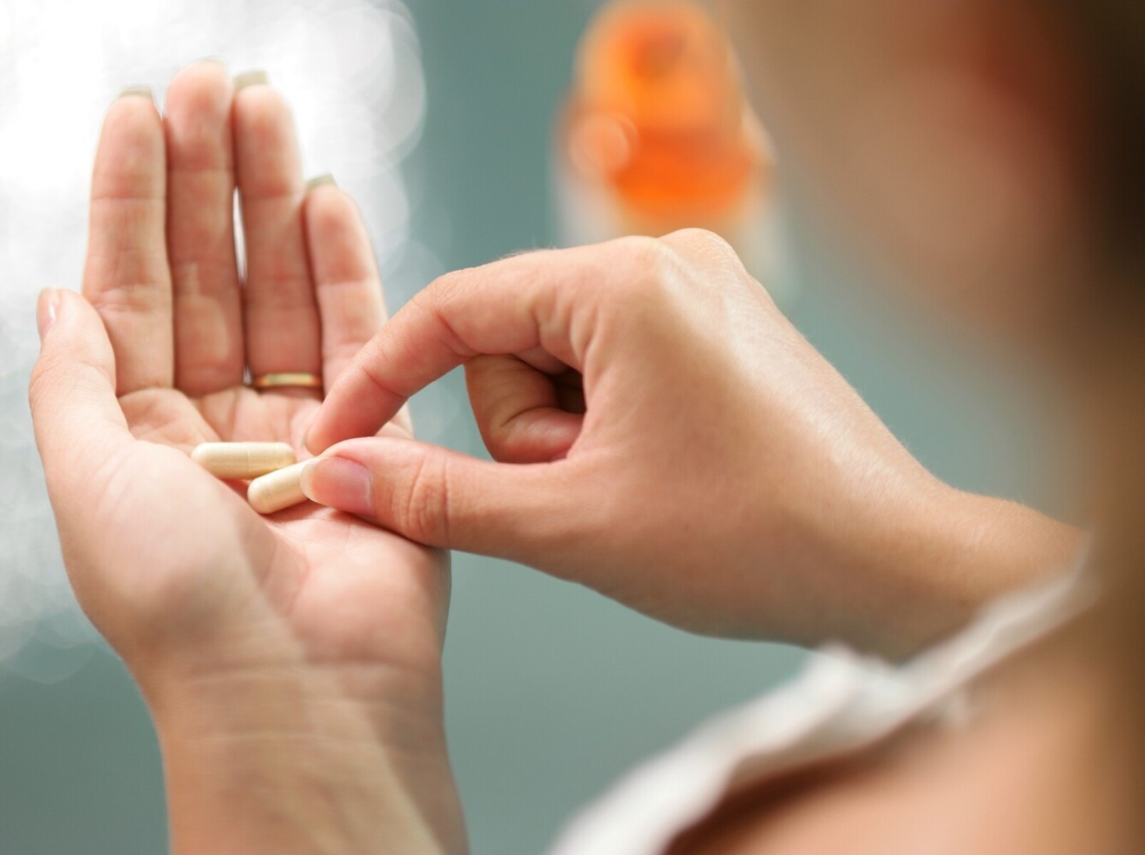 woman looking at natural weight loss medication from over the counter in her hand