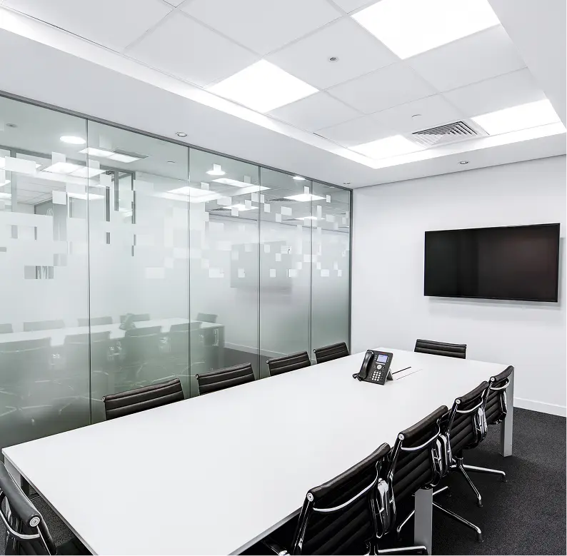Modern living room with vertical garden, yellow sofas, and stylish coffee tables.
