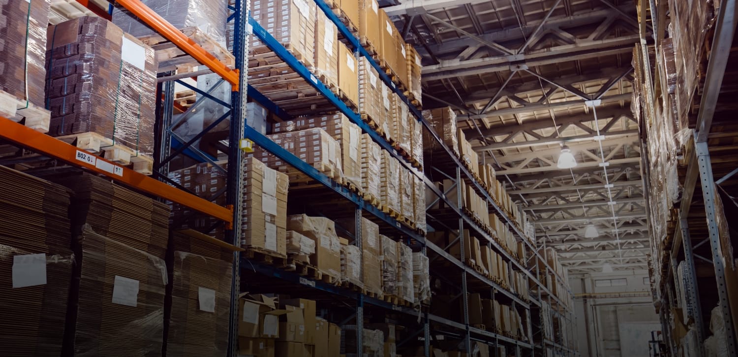 A man pulls a cleaning cart near a building.