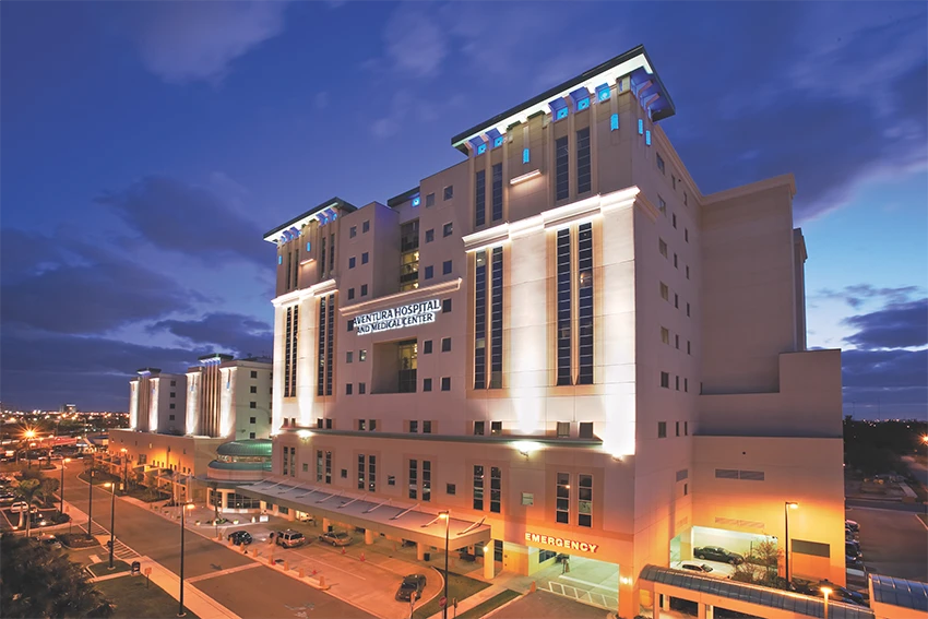 The wedding backdrop is the open sea, shimmering under late afternoon light