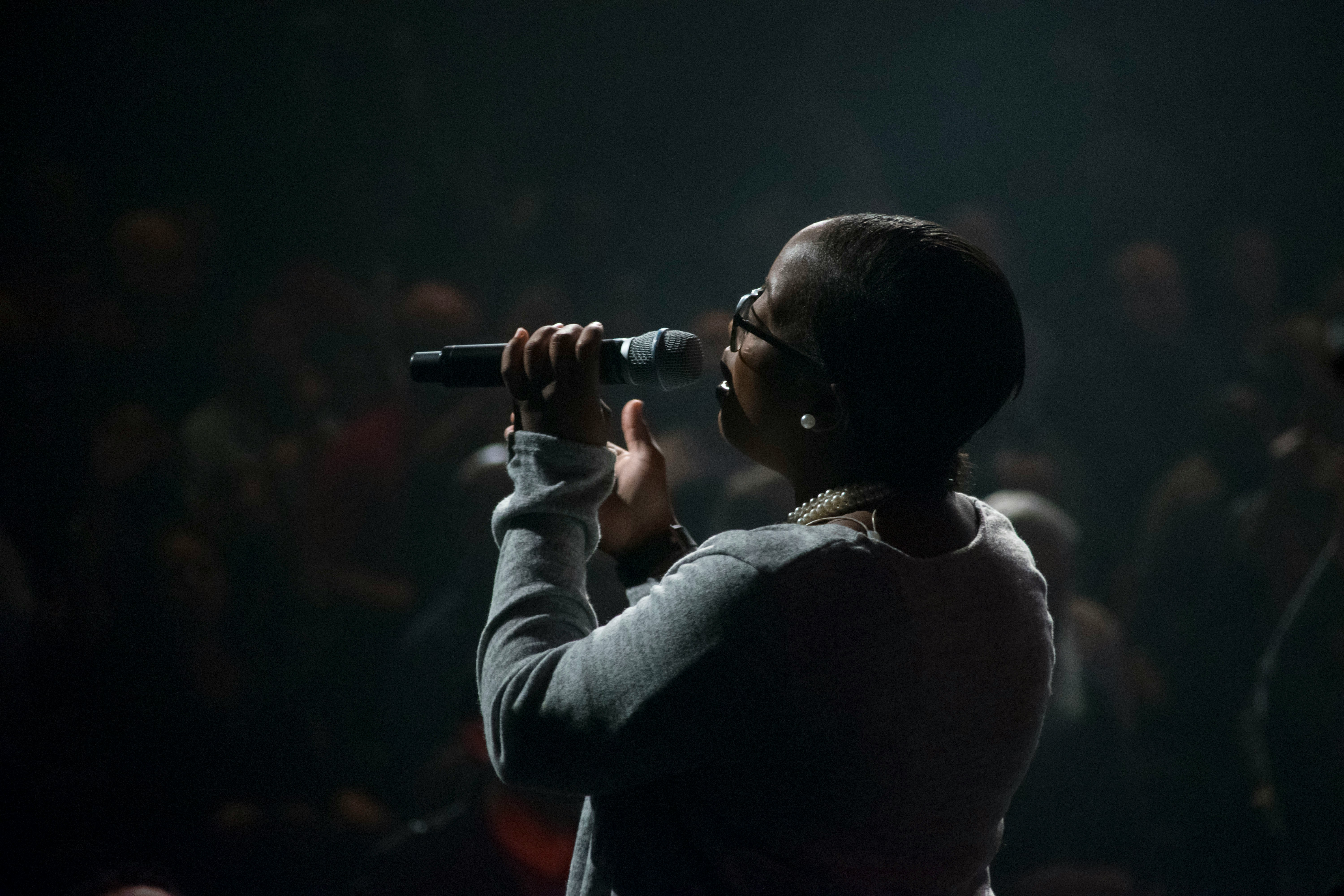 singer on stage with mic - how to write R&B songs