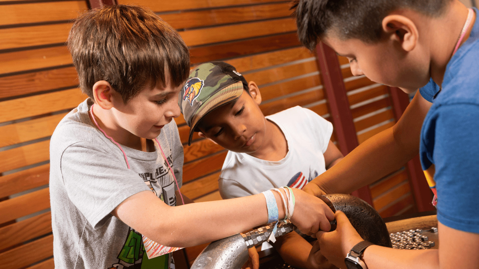 A group of boys work together to put magents together.