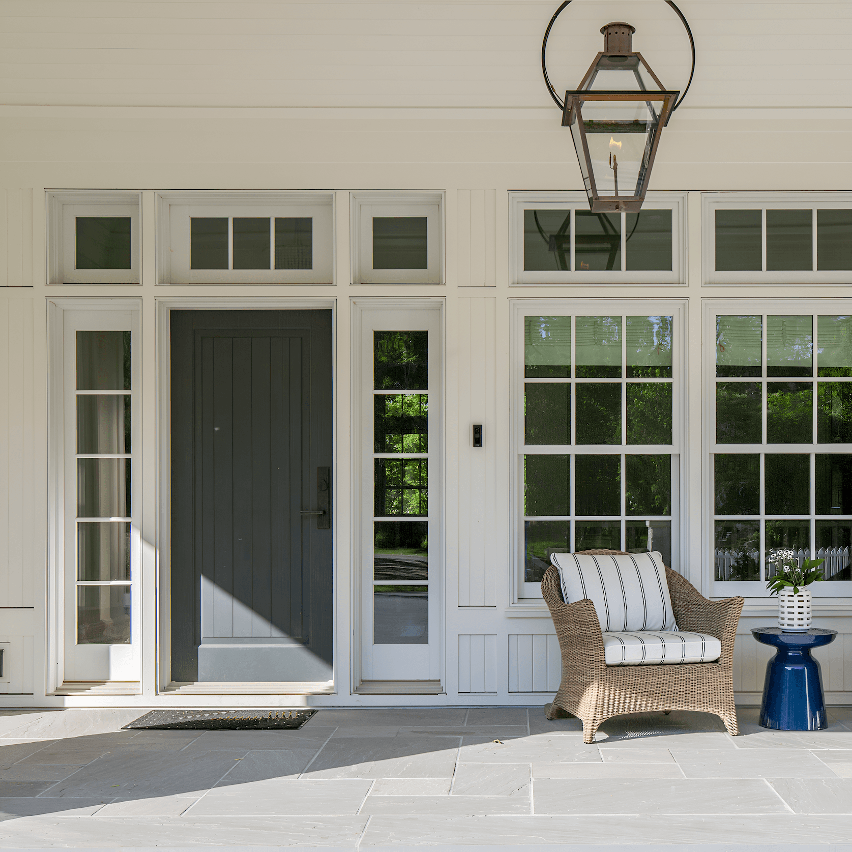 White porch with black door and white lineals.