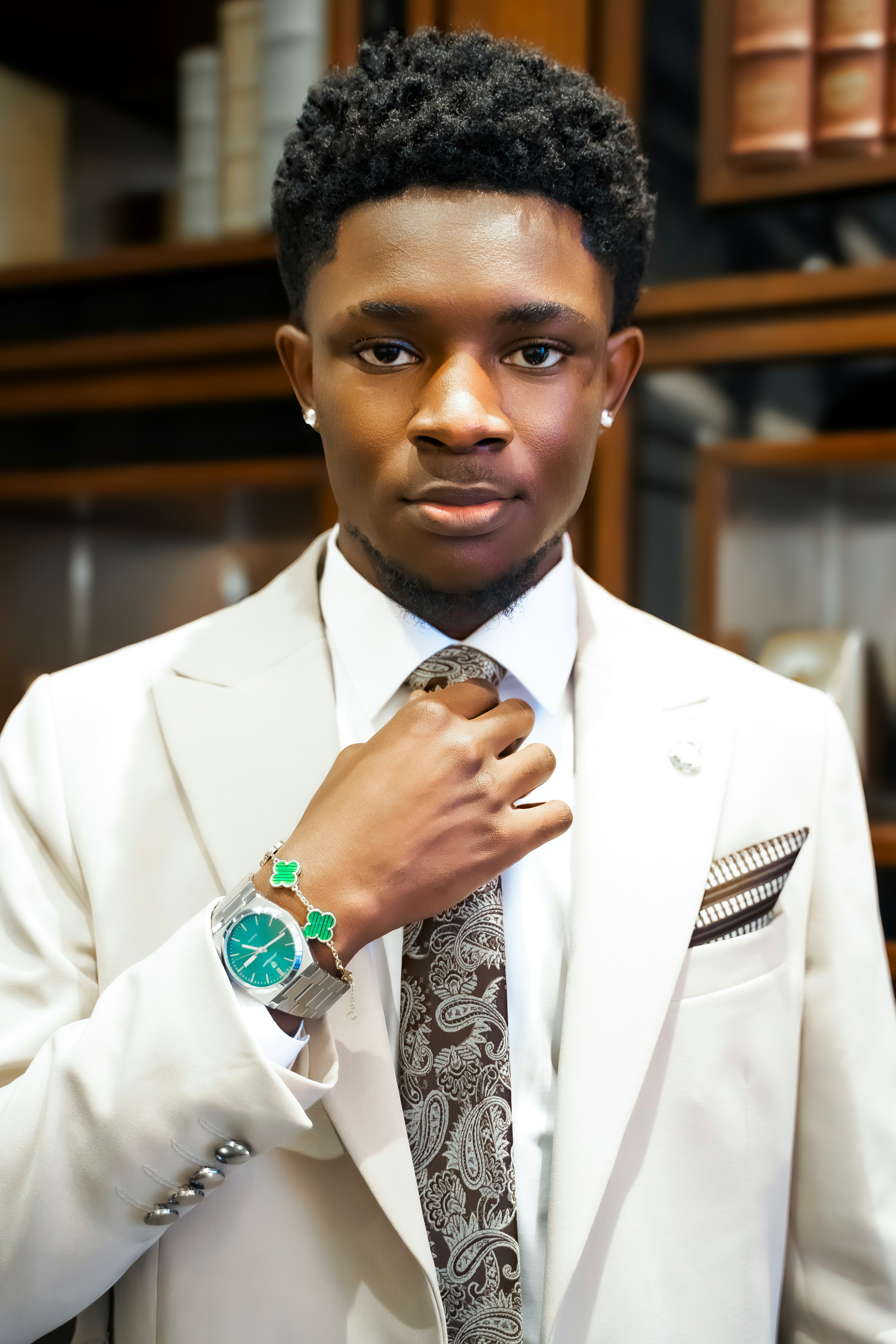 Young man in a suit adjusting his tie