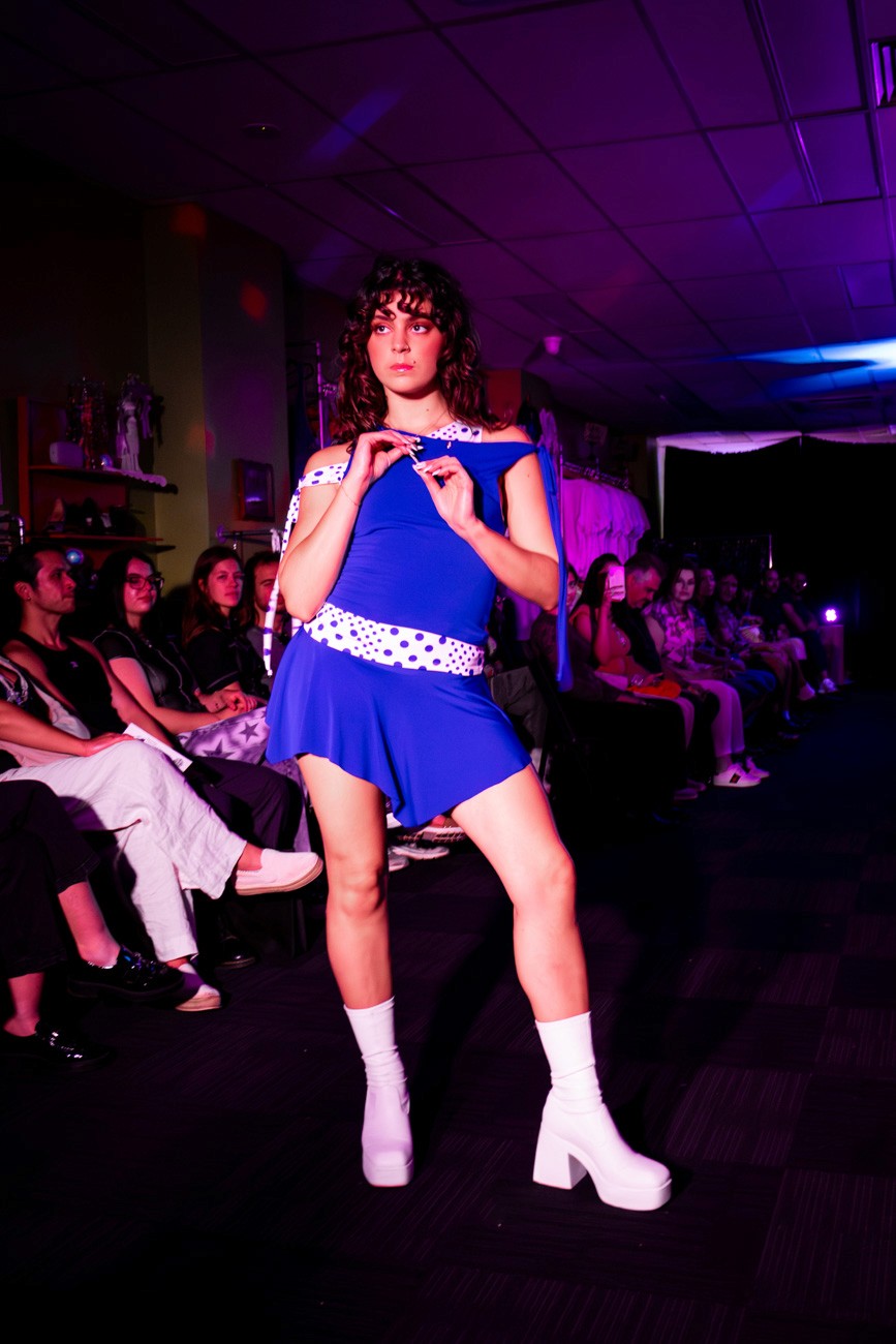 female model on runway wearing blue set