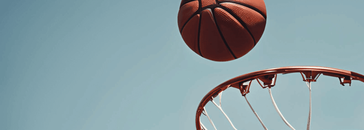 Basketball flying in towards a basketball hoop