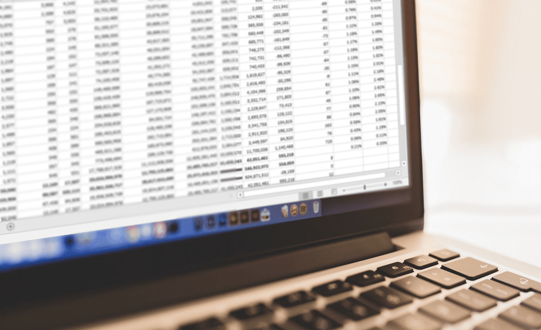 Laptop screen displaying data spreadsheet - How to Calculate Total Revenue in Excel