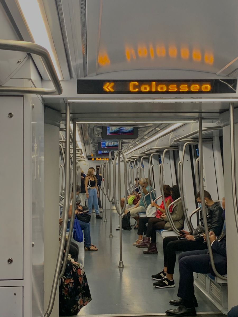 A traveler securely holding their bag while commuting in Rome, emphasizing awareness and safety during city transit.