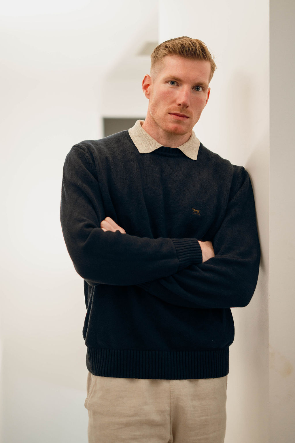 Professional man leaning against wall