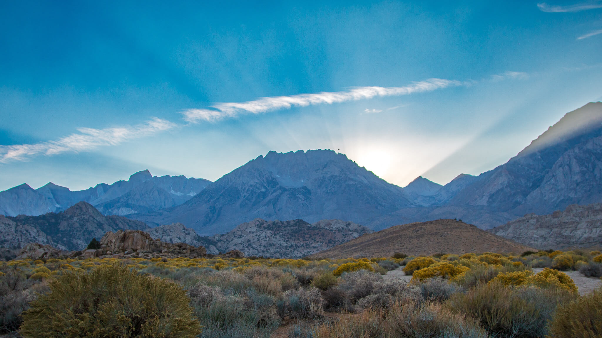light rays over the mountains at sunset