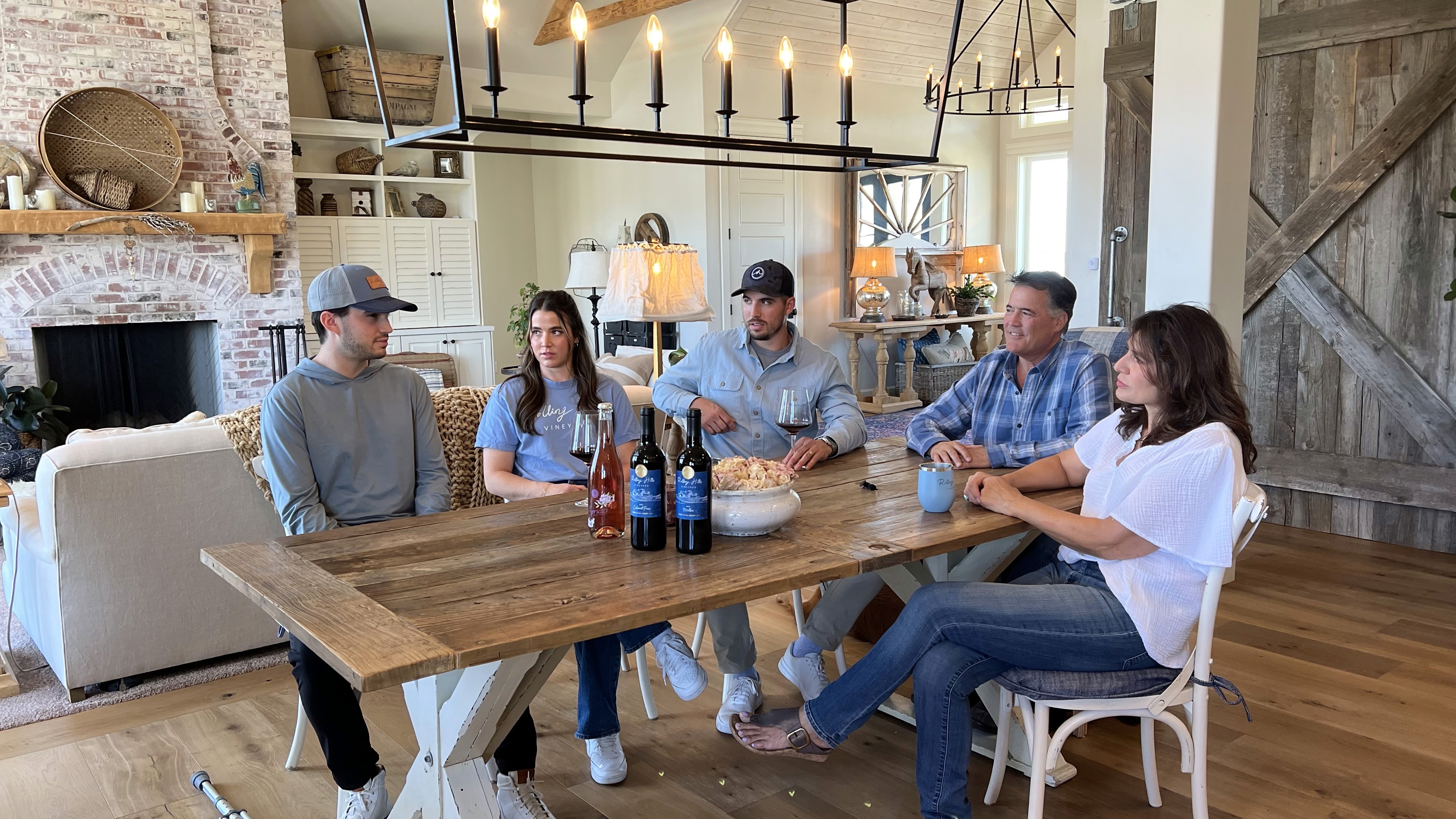 The Pasculli family gathered around a table with Rolling Hills Vineyard wines in Idaho