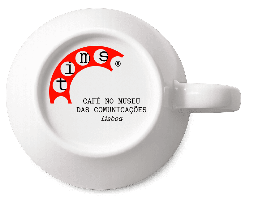 Person with a mustache wearing a black t-shirt carrying a tall stack of pizza boxes inside a dimly lit bar or restaurant.