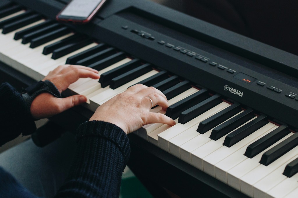 person playing electronic keyboard