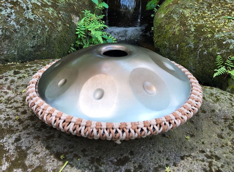 Travel-sized handpan in Thailand, displaying a side view.