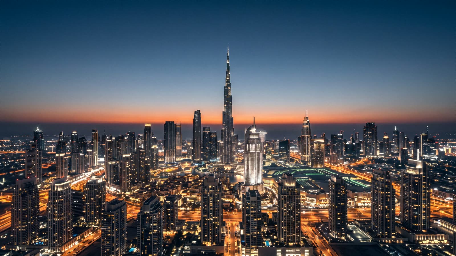 Time-lapse of Downtown Dubai from the air, running from night through sunrise to midday and back