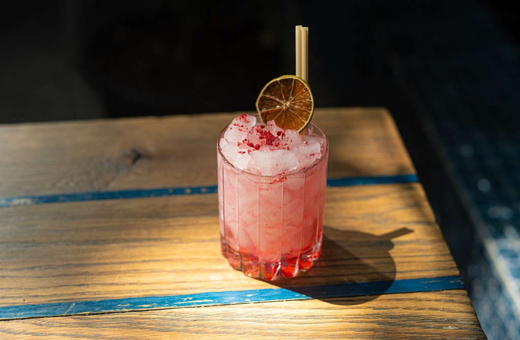 Colorful cocktail served in a glass with garnish