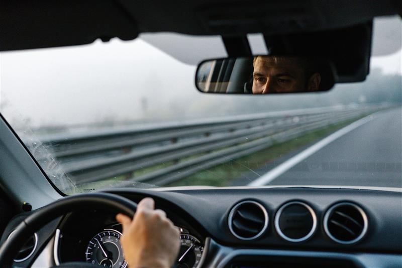 A male driver looking at the road 