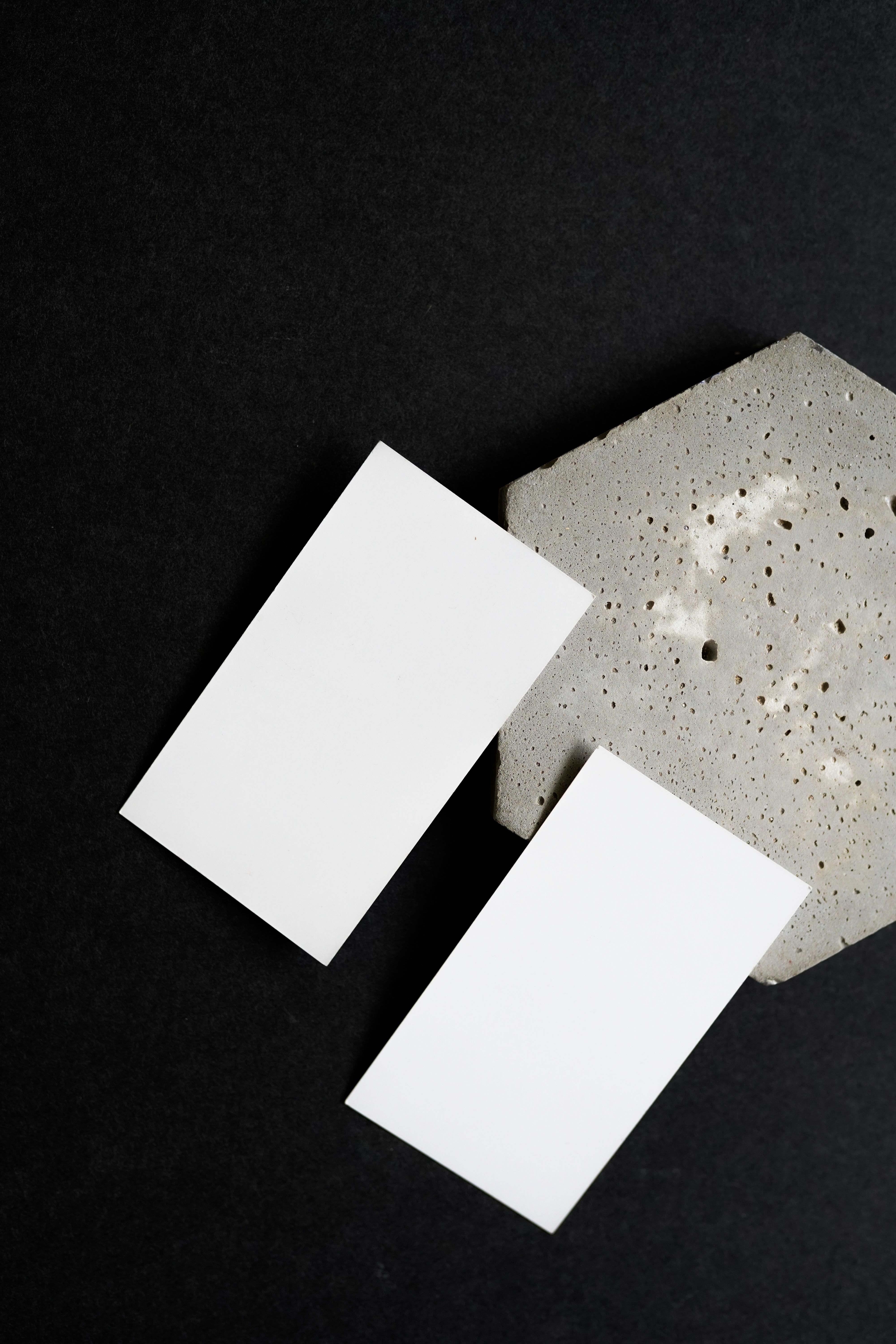 Blank business cards on a dark surface