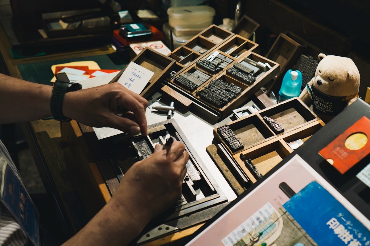 Hands working carefully with printing equipment