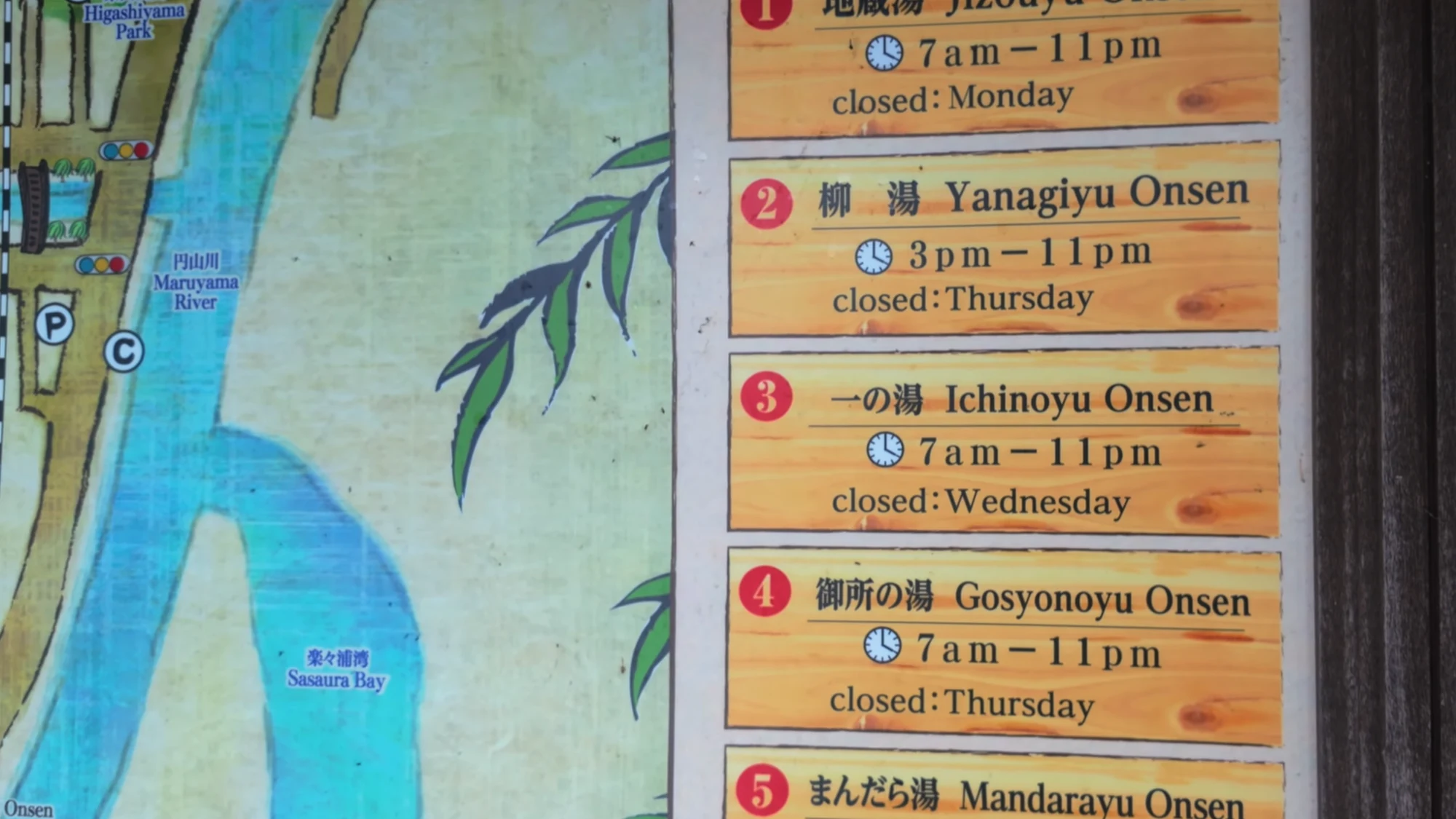 Bilingual Kinosaki map panel listing the bathhouses with their opening hours and weekly closing days.