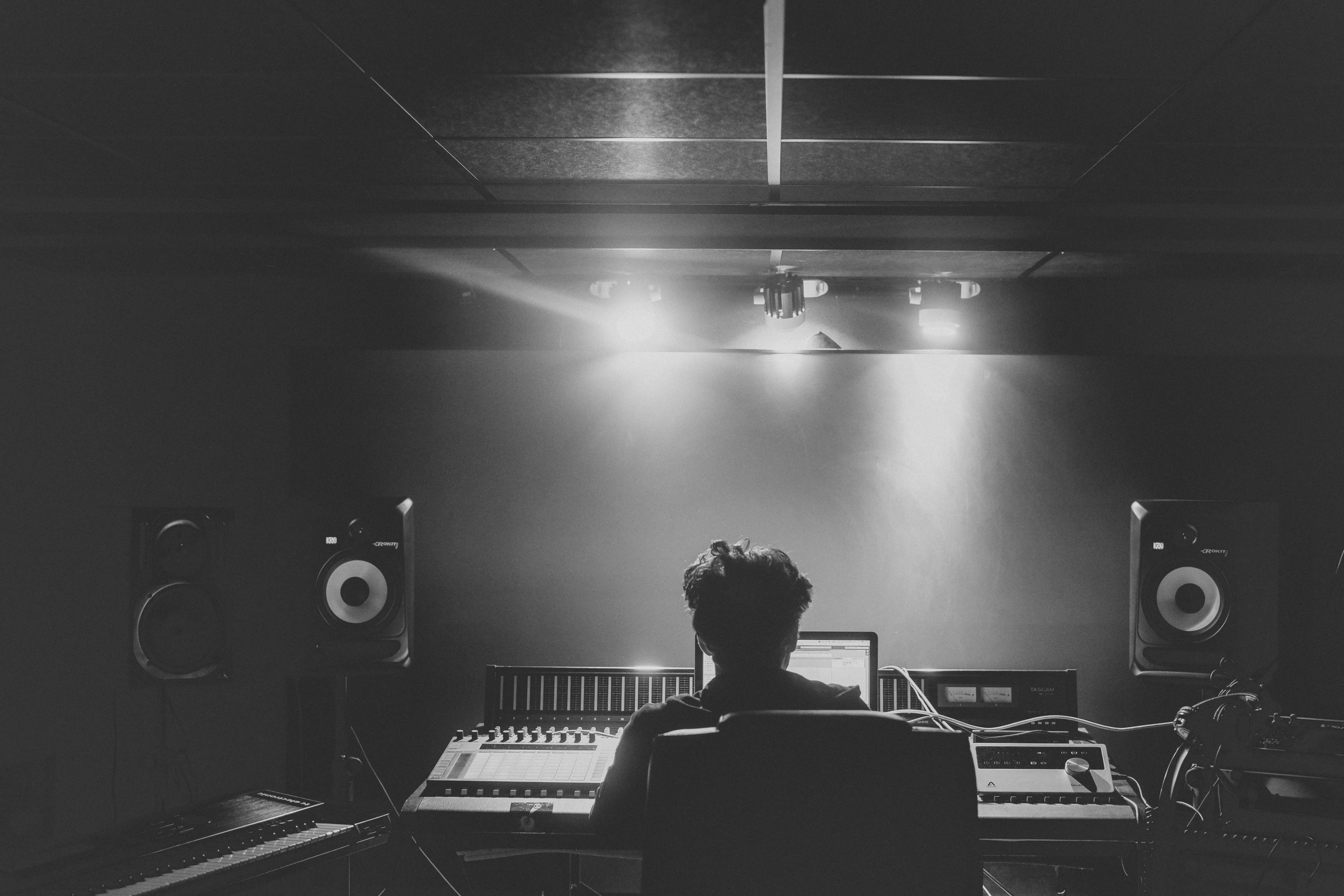 man in music studio working on music - splash pro vs musicfy