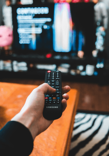 person holding black remote control