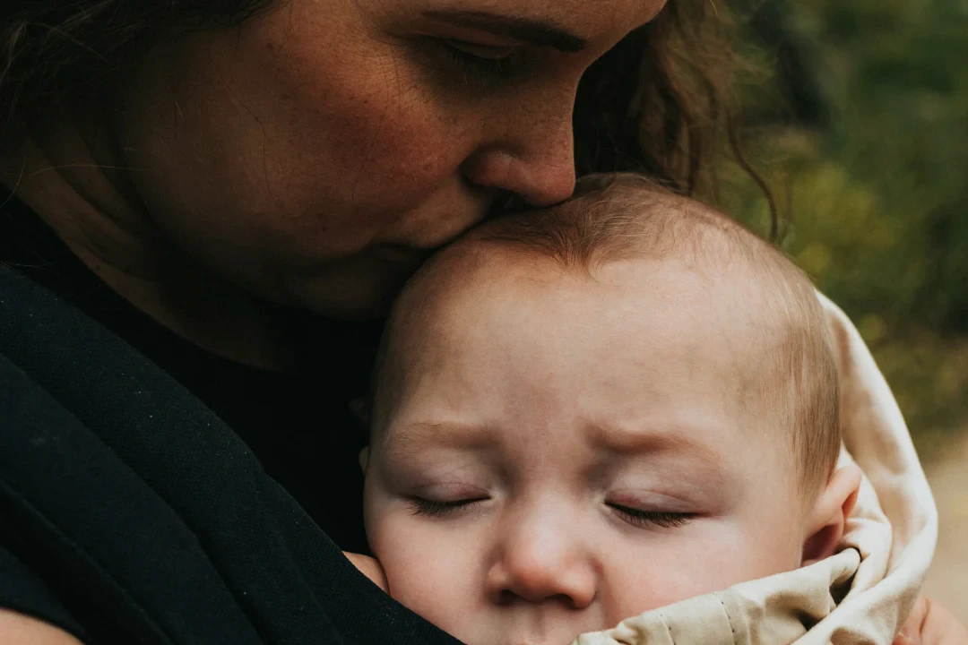 therese kissing her baby's head