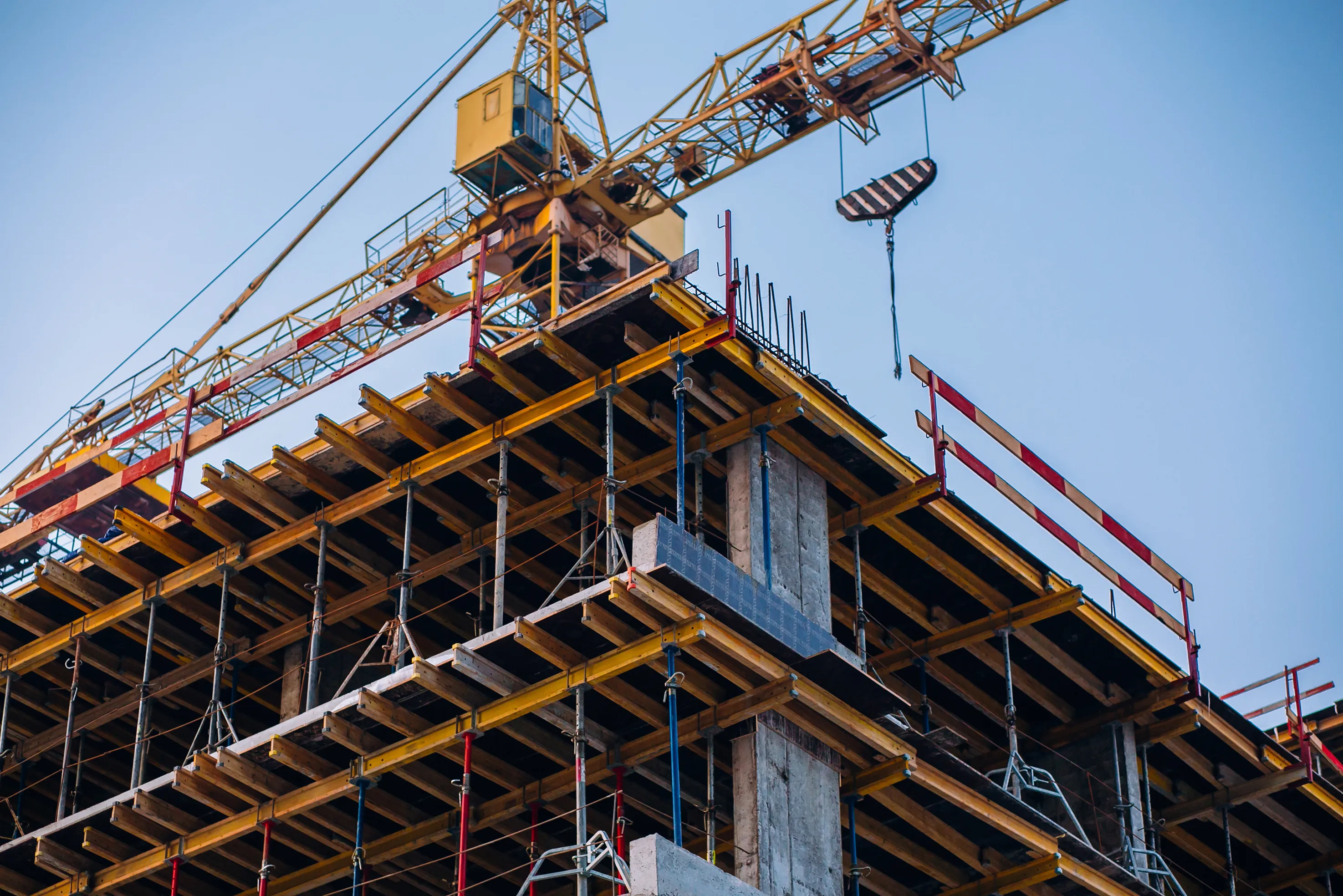 Aerial top-down view of a large residential complex construction site with active cranes.