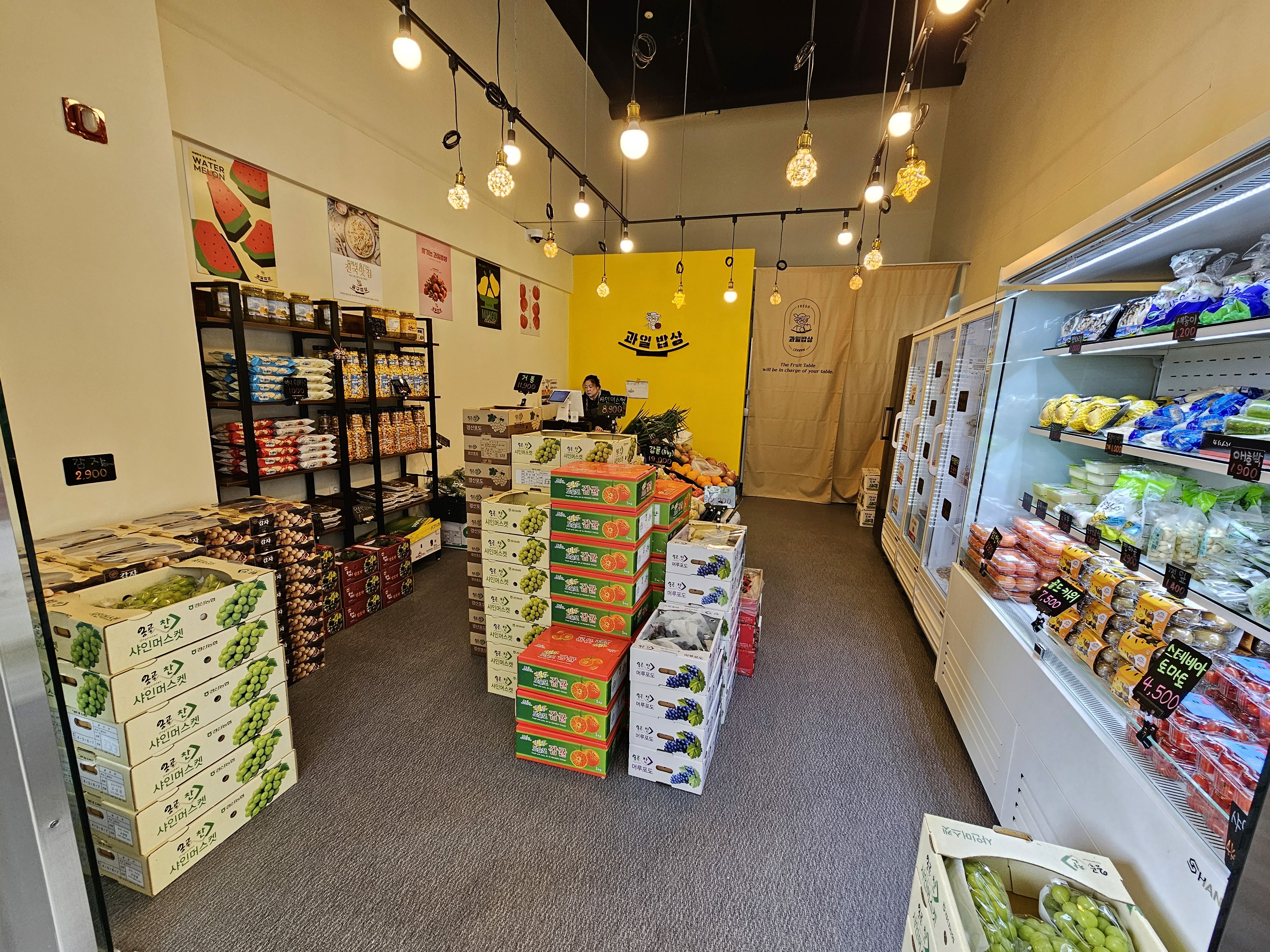 A smiling man wearing a white t-shirt, facing forward with a bright and friendly expression.