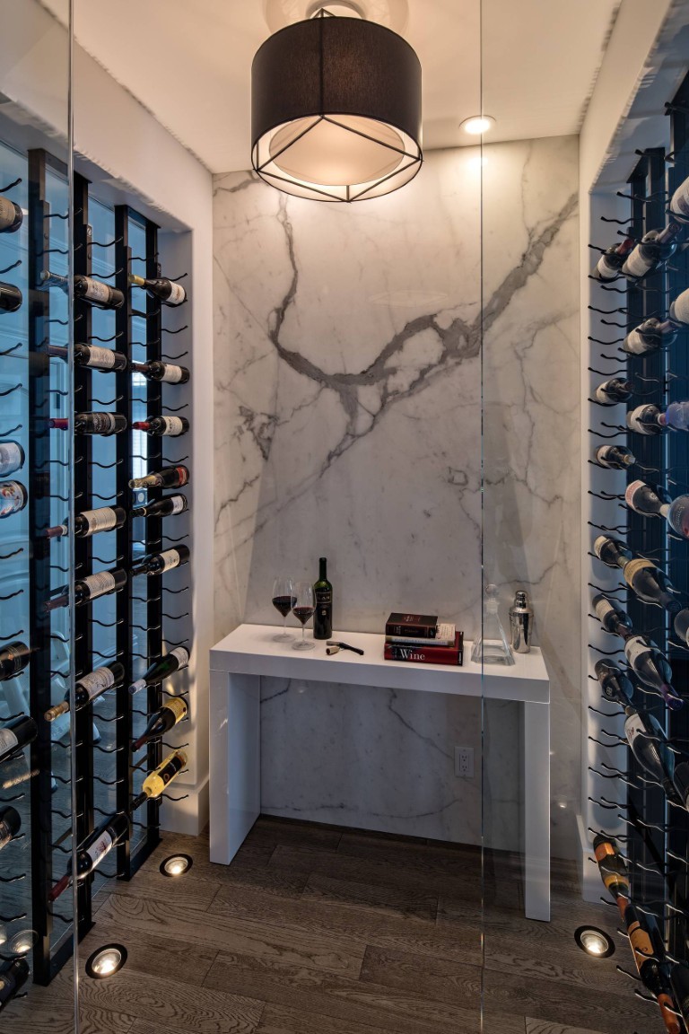 Image of Luxury wine room by KHD Homes featuring marble design, wine storage, and elegant interior layout design elements.