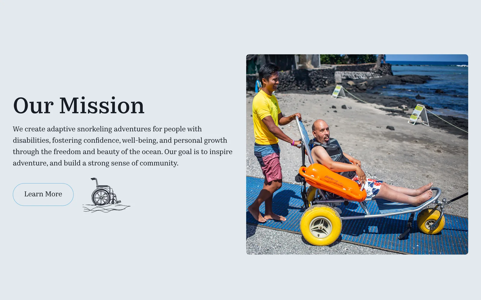 The Our Mission section of the Deep & Beyond website, beside a photo of a volunteer pushing a participant in a beach wheelchair