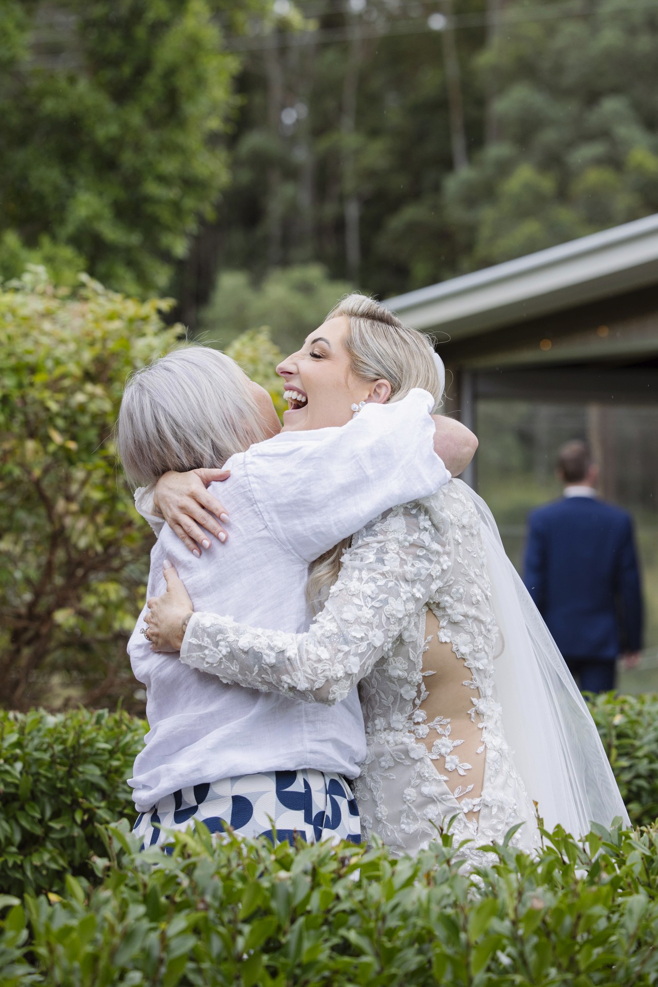 Bride hugging woman