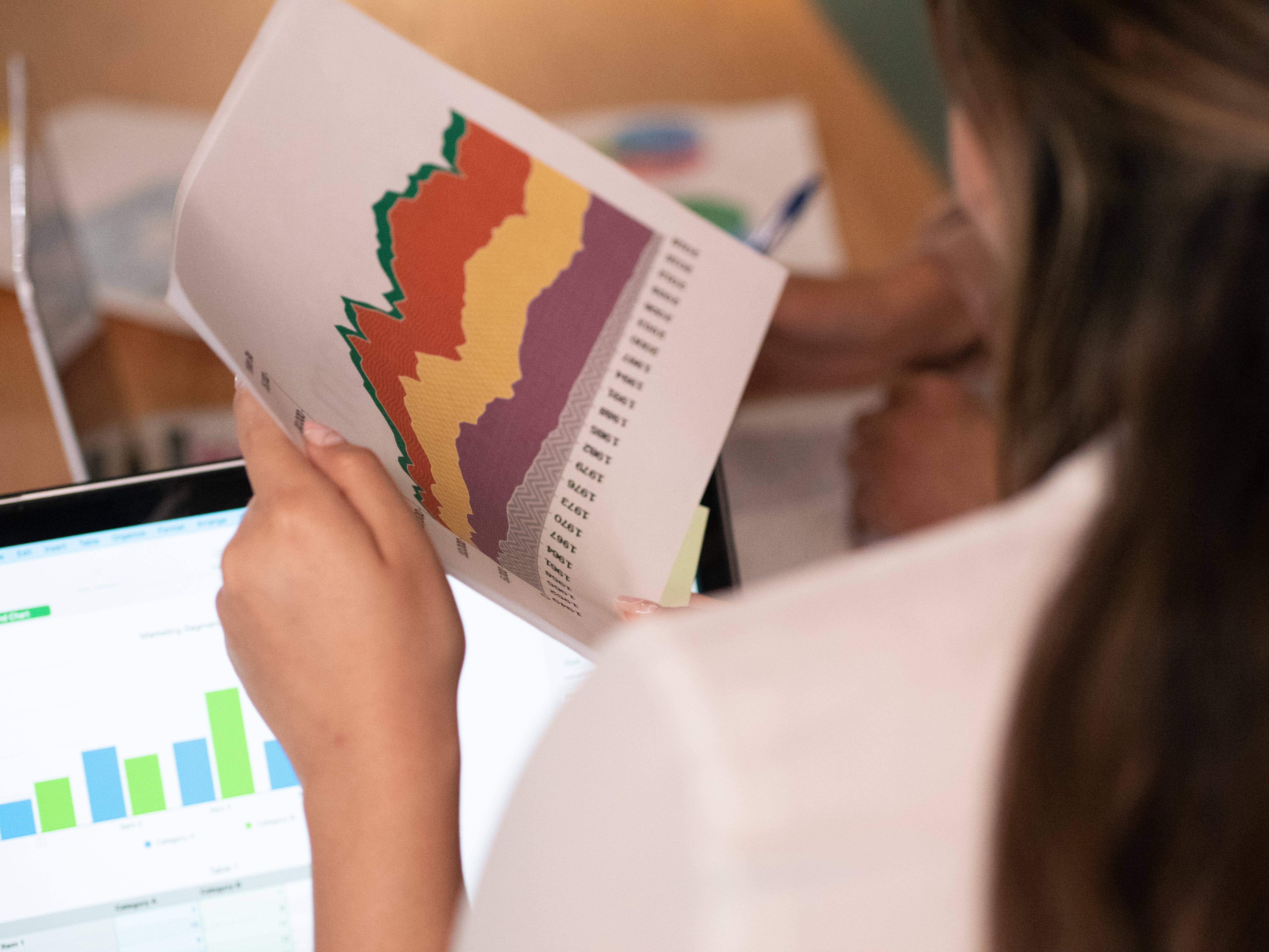 Woman holding documents with information about mortgage rate drop