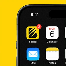 A 3D character viewed from behind with pastel pink hair styled in two buns, wearing a blue knitted sweater and hoop earrings on a light gray background.