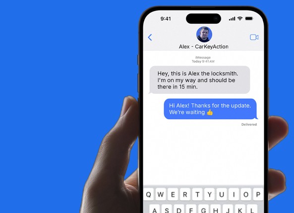 Smartphone showing a text message conversation with a CarKeyAction locksmith confirming arrival time
