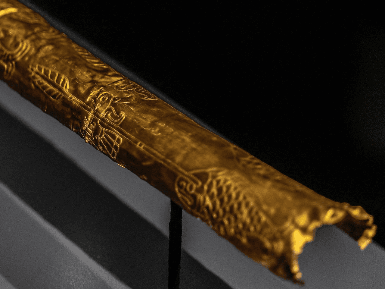 Detailed close-up of the Sanxingdui gold staff with carved patterns