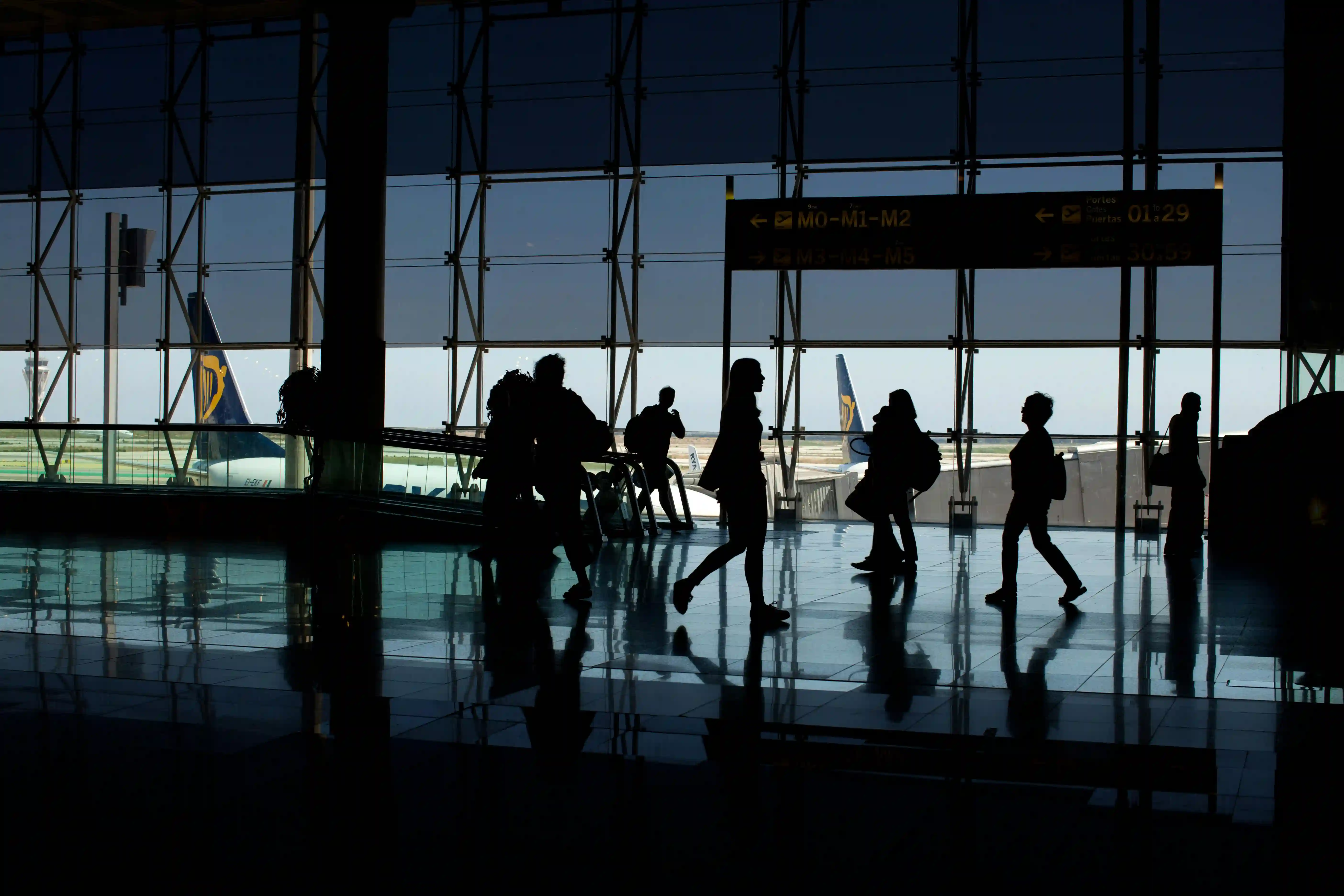 people walking by in a waiting area in the airport