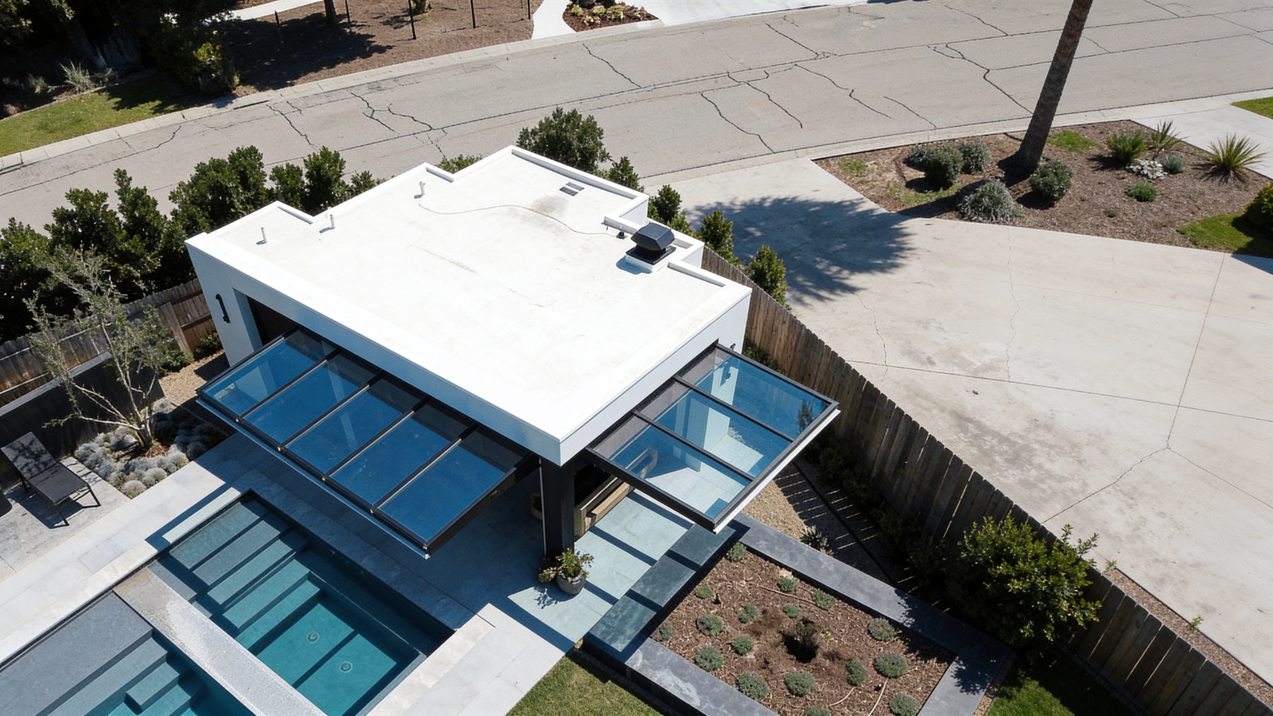 Aerial view of a pool house with concealed cylinder doors and pool