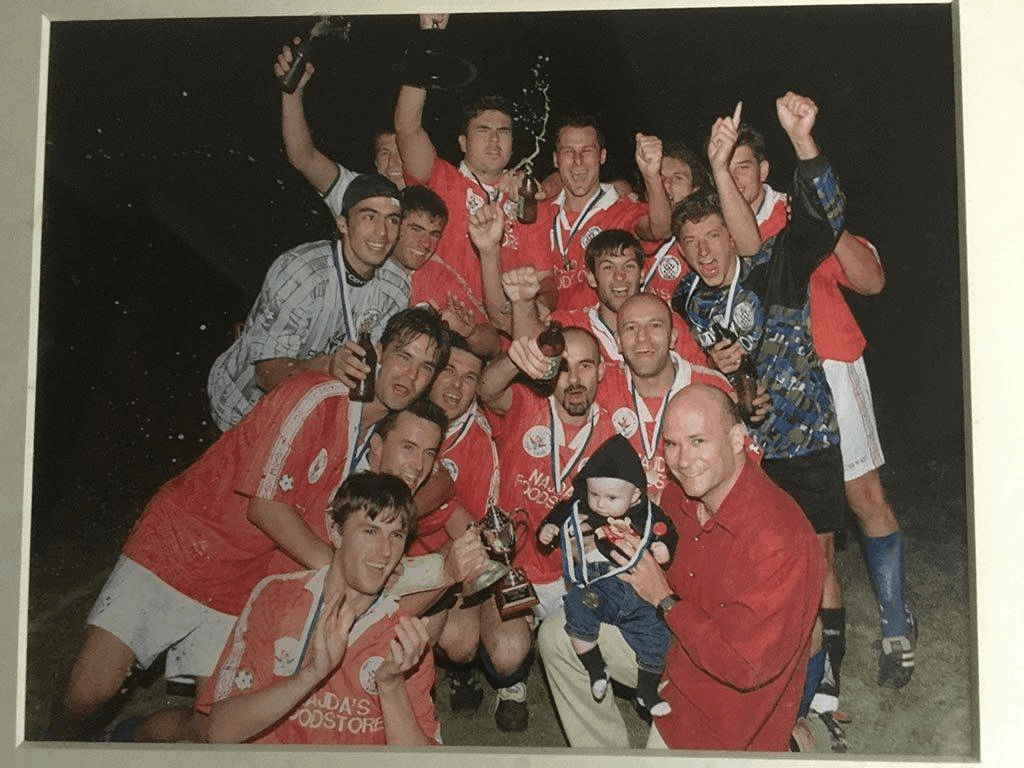 Older North Geelong Warrior's senior team celebrating