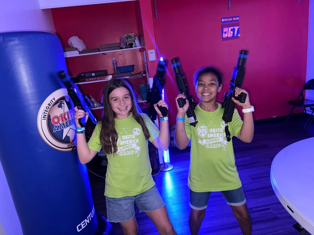 Two girls ready for a laser tag game.